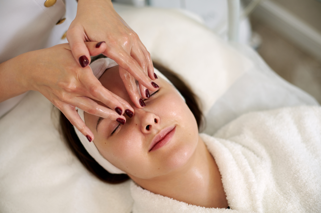 Hands applying the hydrojelly mask during a facial treatment session.